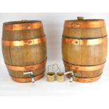 Two coopered oak wine barrels/casks with stoppers, taps and pottery drip trays, height of each 39cm,