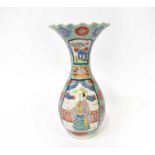 An early 20th century Japanese baluster vase with flared rim, overall enamelled floral decoration