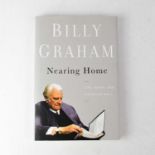 BILLY GRAHAM; 'Nearing Home', a single volume bearing his signature and inscribed 'Phil 1:6'.