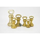 Six brass bell weights, comprising 4lb, 2lb, 1lb (x3) and 8oz examples (6).