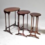 A nest of three oval mahogany side tables, to tapering supports and cross stretchers, the largest 70