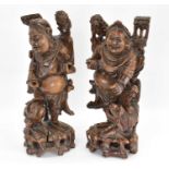 A pair of 19th century carved wood figures of travellers with dog, height of each approx. 39cm.