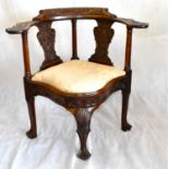 MARITIME INTEREST; an 18th century large corner chair with floral and leaf carved back rail and