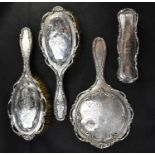 An Edwardian hallmarked silver four-piece dressing table set, comprising hand mirror, length 26cm,