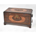 An early 20th century carved camphor wood chest on bracket feet, 46 x 86 x 41cm.