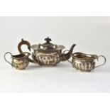 An Edwardian hallmarked silver three-piece tea set, demi-gadrooned, comprising teapot, twin-