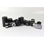 A collection of cameras and lenses to include a Panasonic Lumix DMC-G5, a Panasonic Lumix DMC-TZ3,
