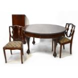 A 20th century mahogany oval extending dining table to four tapering ball and claw supports,