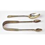 A pair of hallmarked silver sugar tongs and a hallmarked silver spoon, with initials to terminus,