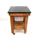 A modern heavy butcher's block trolley table with detachable chamfered black slate top, with slatted