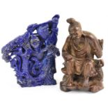 A Chinese lapis lazuli carved figure of a lady holding a lantern, amongst trees, with vase back,