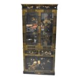 A Chinese black lacquered glazed bookcase decorated with chrysanthemums and bamboo with flying