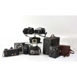 A collection of cameras to include an Olympus OM10, an Olympus OM2, a Voigtlander Brilliant, etc.