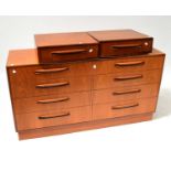 G-PLAN; a teak chest of eight long drawers, with stylised handles, on a plinth base, 76 x 42 x 45cm,