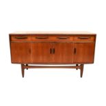 A 1960s teak sideboard with three frieze drawers above a pair of panelled doors flanked by two