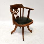 An oak office captain's swivel chair with green leather padded seat.Condition Report: Overall