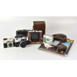 A collection of cameras to include a Zeiss Ikon Nettar, a Voigtlander VF135, a Kodak Instamatic