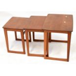 A mid-20th century teak nest of three tables on stylised supports, the largest 51 x 57 x 40cm.