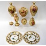 ROYAL WORCESTER; a pair of cabinet plates with painted armorial and floral decoration, by Edward