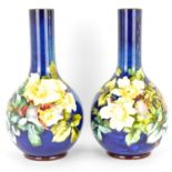 DOULTON LAMBETH; a pair of 19th century Faience bottle vases, slender stem to globular body,