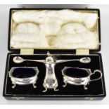 An Elizabeth II hallmarked silver cruet, comprising pepperette, salt, mustard both with blue liners,