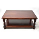 A mahogany coffee table with tuned supports and under shelf, 50 x 125 x 90cm.