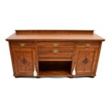 An early 20th century oak sideboard with bank of two drawers over open storage, flanked by single