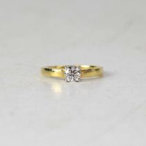 A 9ct yellow gold diamond solitaire ring, the four-claw set round brilliant cut stone weighing