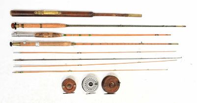 Four vintage fishing rods including two split cane examples, one with remnants of maker's label