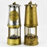 Two vintage miners' lamps, both titled 'The Protector Lamp 7 Lighting Co, Eccles, Manchester', one