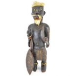 A South Pacific style carved wood warrior figure, with hair, moustache and beard, possibly real,