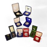 Seven boxed commemorative silver and white metal coins relating to the QEII, mainly dating from