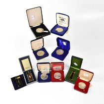 Seven boxed commemorative silver and white metal coins relating to the QEII, mainly dating from