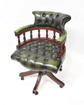A modern green leather desk swivel chair.