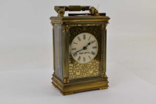 MAPPIN & WEBB LTD; an ornate brass carriage clock with a blind pierced face, the white enamelled