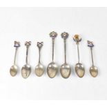 Seven silver commemorative spoons for the Royal Mail shipping line, six with enamelled finials and