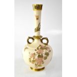 ROYAL WORCESTER; a blush ivory twin-handled onion-shaped vase with reticulated gilt-heightened