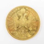 A 1915 Austrian 100 Corona 0.900 fine gold (21ct) coin, 1975 restrike, diameter 37mm, 33.97g.