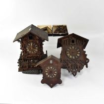 A group of three wooden cuckoo clocks, height of tallest 36cm. (3) Condition Report: - Please note