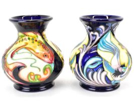 MOORCROFT; two small baluster vases with flared rims, each decorated in a different tube lined