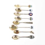 Eight silver commemorative spoons for P&O Shipping Line, some with enamelled finials, some with