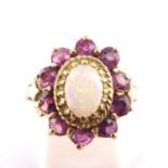 An 9ct gold opal and pink topaz set cluster ring, the central claw set white opal with flashes of