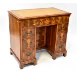 TITCHMARSH & GOODWIN, IPSWICH; a George III style yew wood small pedestal desk, with thumb-moulded