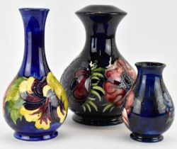 MOORCROFT; three items of blue ground pottery, comprising a globe and shaft shaped 'Hibiscus'