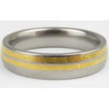 FENIOM; a titanium and yellow gold inlaid ring, size S.