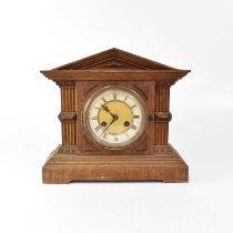 An early 20th century oak cased architectural mantel clock, with Junghans twin fusee movement