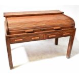 A c.1930s oak office desk with tambour roll-back top and interior pigeonholes, above two single