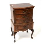 A reproduction mahogany crossbanded serpentine-fronted four-drawer bedside chest, raised on carved