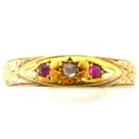 A gold ring made from a 9ct gold oval head with central tiny diamonds flanked by two tiny rubies,