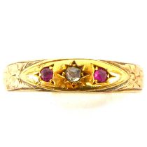 A gold ring made from a 9ct gold oval head with central tiny diamonds flanked by two tiny rubies,